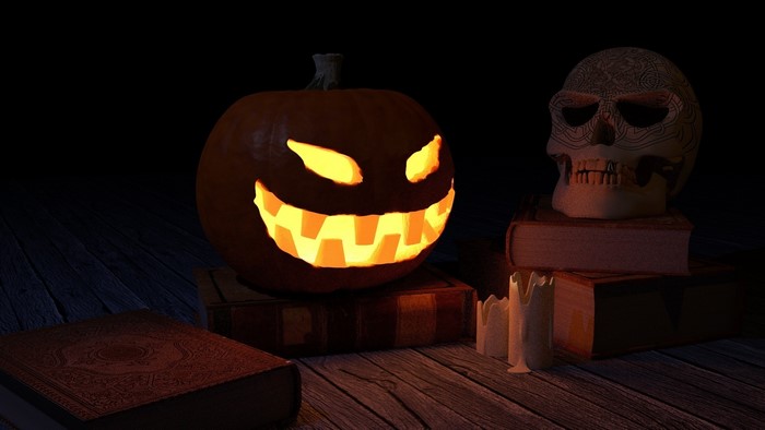 Halloween pumpkin and skull on books