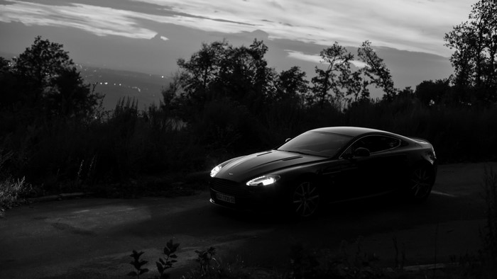 Aston Martin A8 on a road at dusk