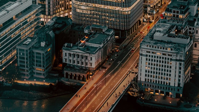 Aerial view of a city bridge and buildings at night