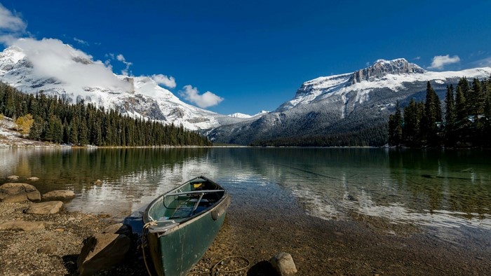 Canoe on Emerald Lake with Snow-Capped Mountains