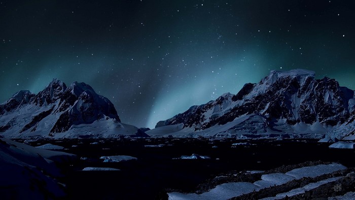 Snowy Mountains Under Aurora Borealis
