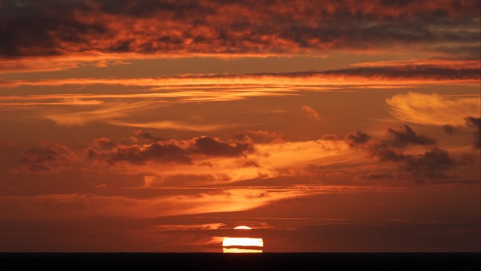 Sunset over the ocean with clouds