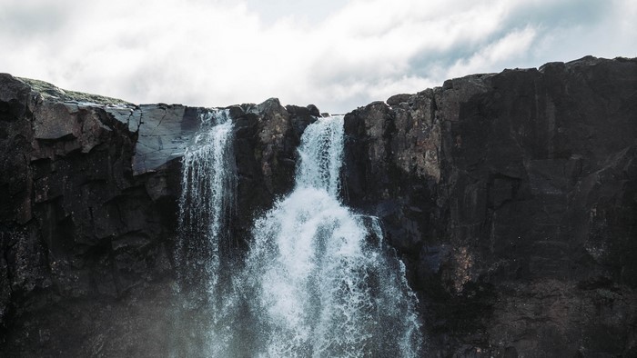 Waterfall cascading over dark rocks