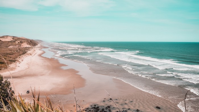 Beach with waves and sand dunes