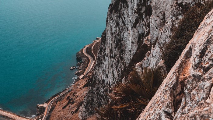 Coastal road winding along a cliff by the sea