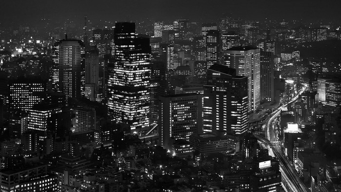 Night cityscape with illuminated skyscrapers and highways