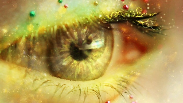 Close-up of a stylized eye with glitter and jewels
