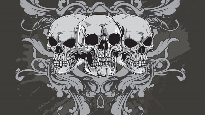 Three skulls with ornate filigree