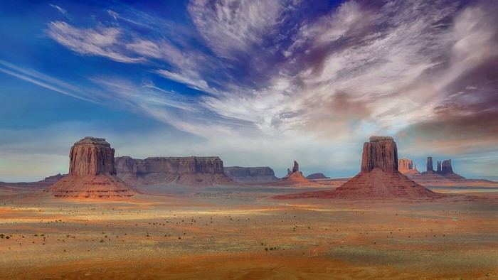 Monument Valley desert landscape with mesas and clouds