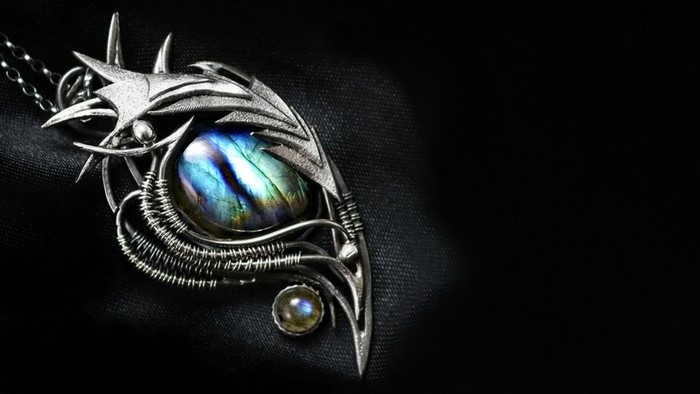 Ornate silver pendant with labradorite gemstone