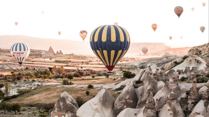 Hot air balloons over Cappadocia landscape
