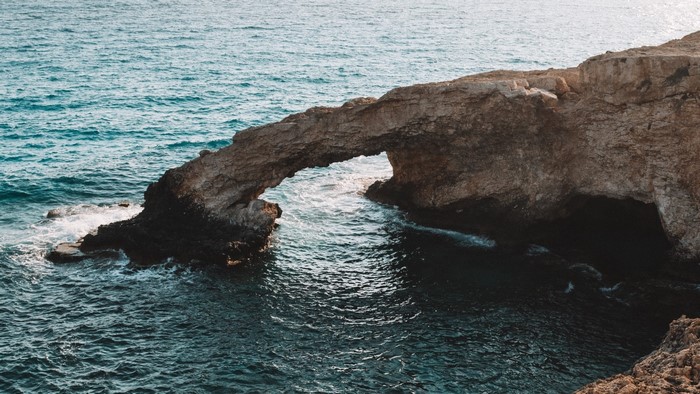 Natural rock arch over the sea