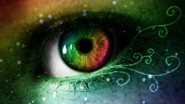 Close-up of a rainbow-colored eye with green swirls