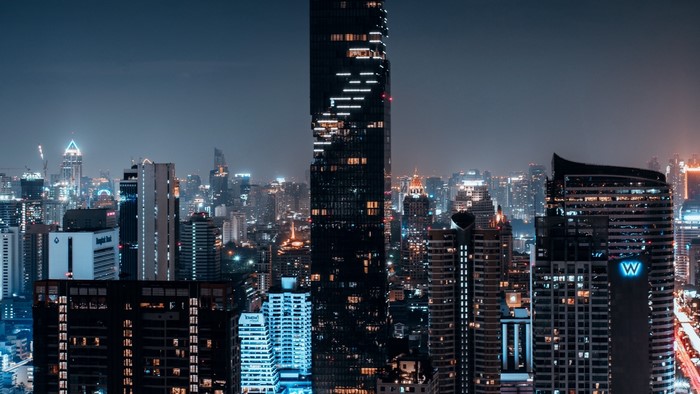 Night city skyline with illuminated skyscrapers