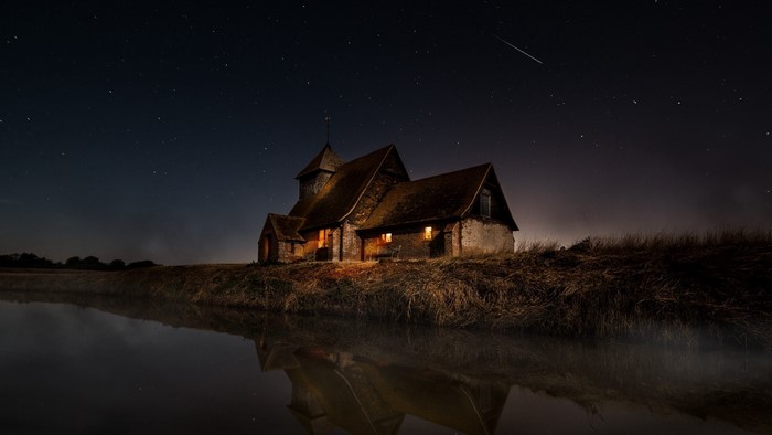 Church at night with stars and reflection