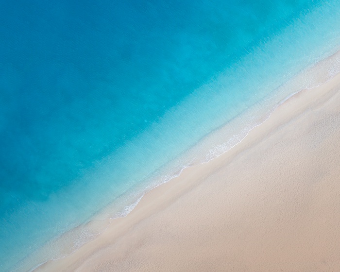 Aerial view of a tropical beach with turquoise water