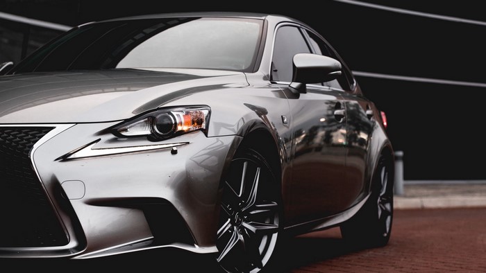 Lexus IS sedan parked on brick pavement