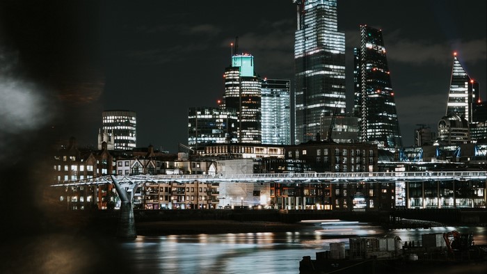 Night city skyline with river and bridge
