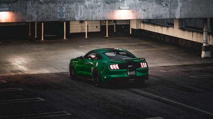 Green Ford Mustang GT parked in a garage