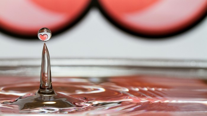 Water drop with heart reflection