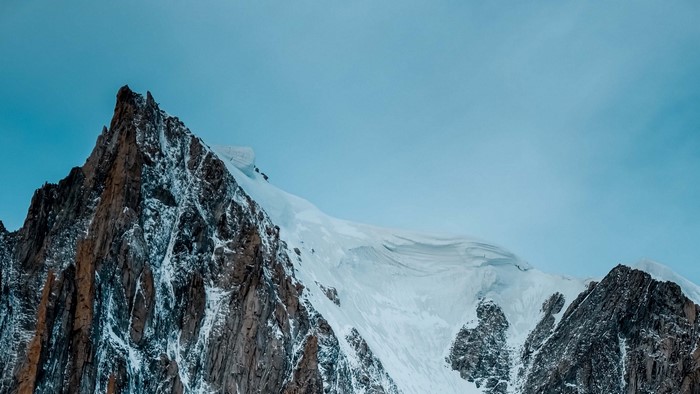 Snow-covered mountain peak against a clear sky