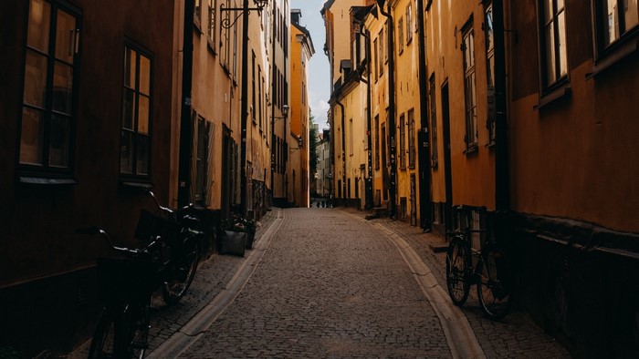 Narrow cobblestone street between old buildings