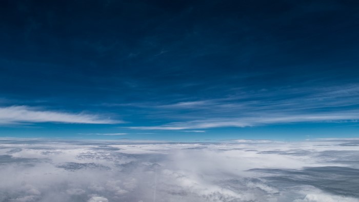 Clouds and blue sky from airplane window
