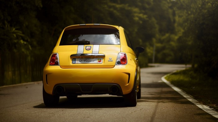 Yellow Abarth 695 Tributo Ferrari on a Road