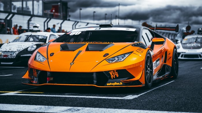 Orange Lamborghini race car on track