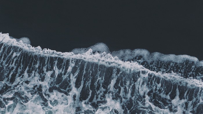 Waves crashing on a dark shore