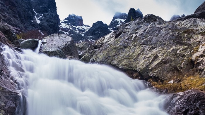Waterfall cascading down rocky mountain