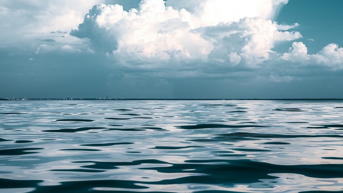 Ocean waves under a cloudy sky