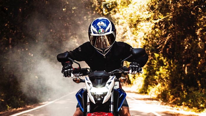 Motorcyclist wearing AGV helmet riding a motorcycle
