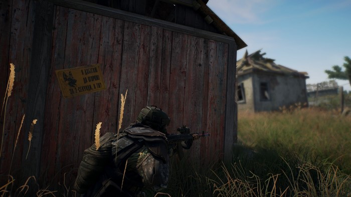 Soldier aiming rifle near wooden building in Survarium