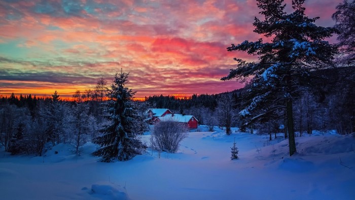 Winter Sunset Over Snowy Landscape with Red Houses