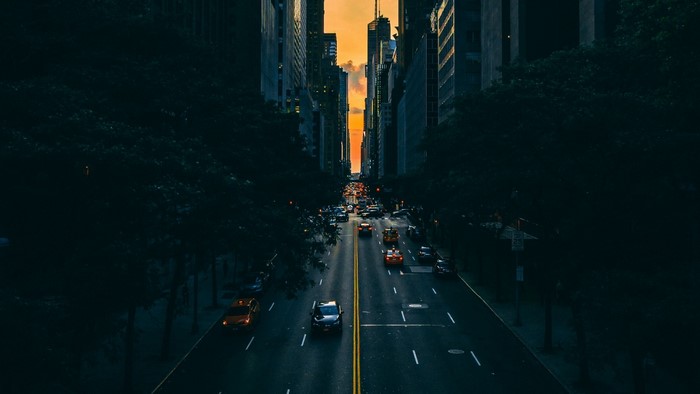 Cars on a street in Manhattan at sunset