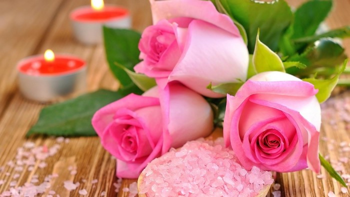 Pink roses with candles and bath salts