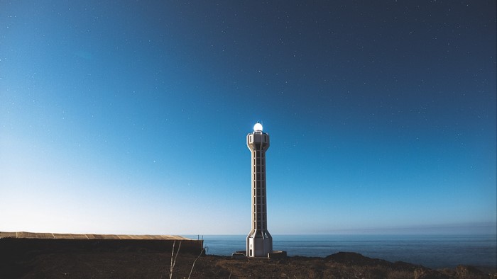 Lighthouse under a starry night sky
