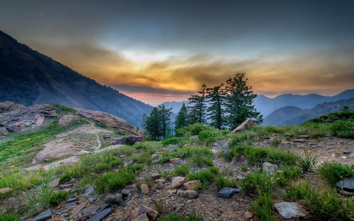 Mountain landscape at sunset with smoke in the sky