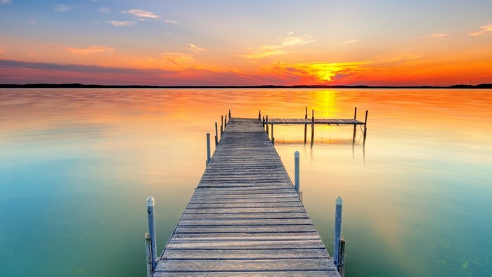 Wooden pier on a lake at sunset