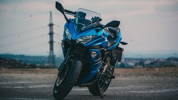 Blue Kawasaki motorcycle parked outdoors