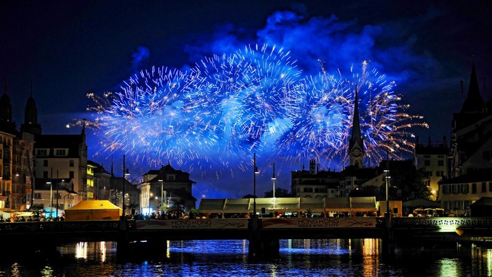 Blue Fireworks over Cityscape with River