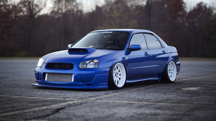 Blue Subaru Impreza WRX STi with white wheels
