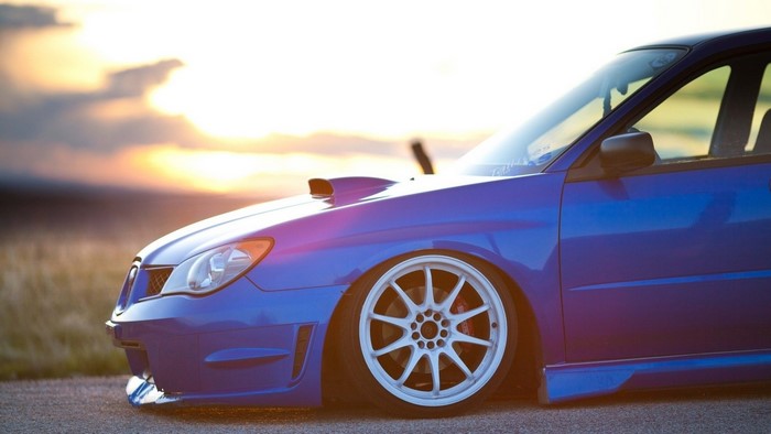 Blue Subaru Impreza WRX STI with custom wheels