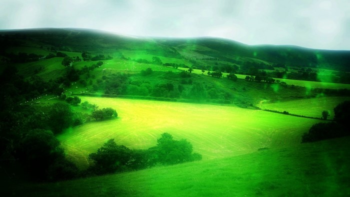 Green rolling hills with a bright field