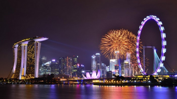 Singapore skyline with fireworks and Ferris wheel