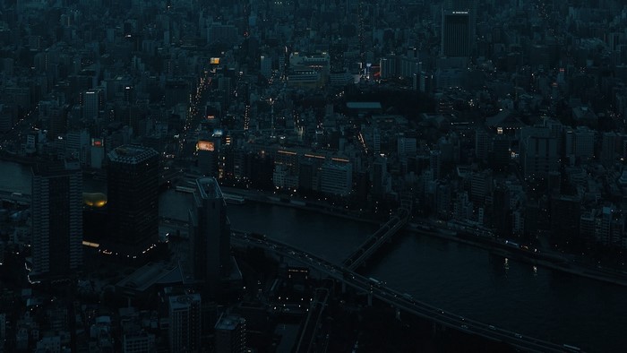 Aerial view of a city at night with a river