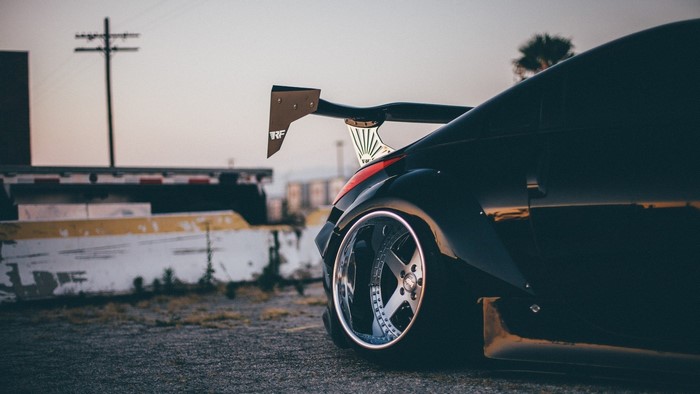Black Nissan 350Z with spoiler and custom wheels