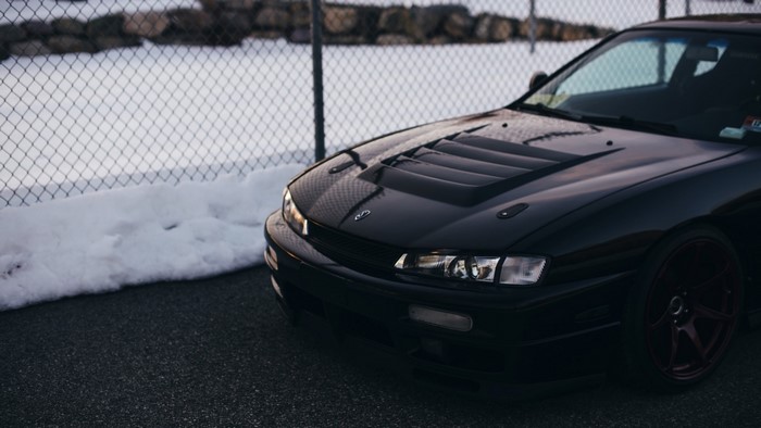 Black Nissan Silvia S14 with custom hood