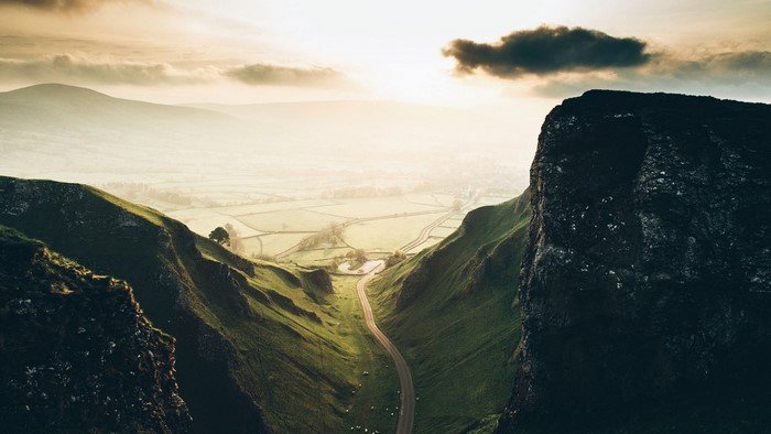Valley with a road and mountains at sunrise